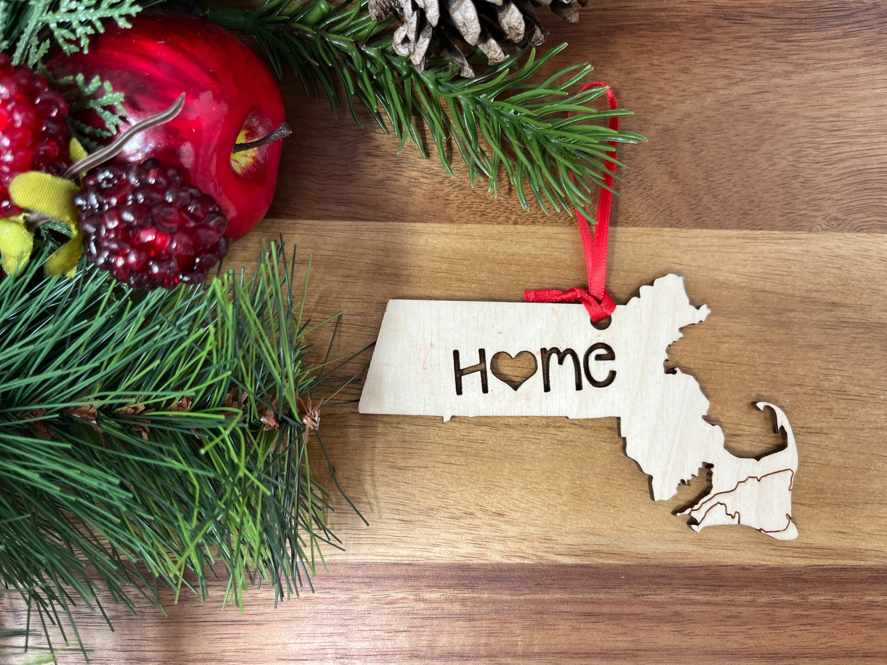 A charming Massachusetts State Wood Christmas Ornament featuring a 'Home' design, made from premium Baltic Birch wood.