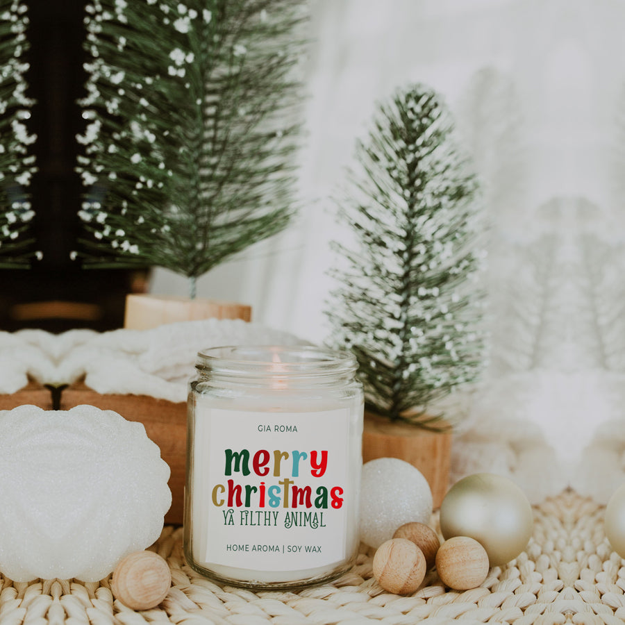 A beautifully designed Merry Christmas Candle in a 9oz jar, featuring a festive label and a warm glow, perfect for holiday decor.