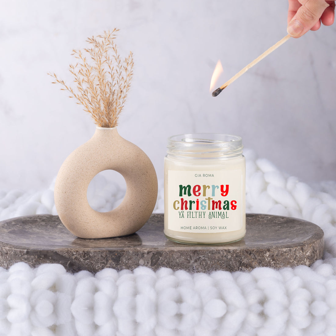 A beautifully designed Merry Christmas Candle in a 9oz jar, featuring a festive label and a warm glow, perfect for holiday decor.