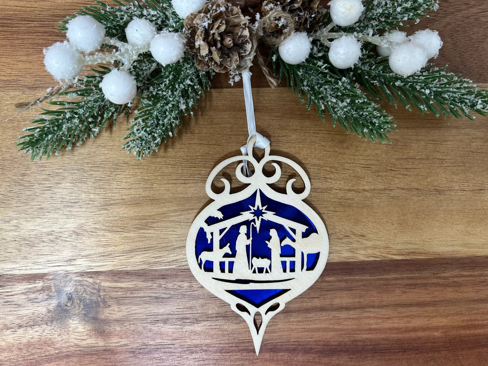 Nativity Bulb ornament made from premium Baltic Birch wood, intricately laser cut with a beautiful design, packaged in a cotton-filled jewelry box.