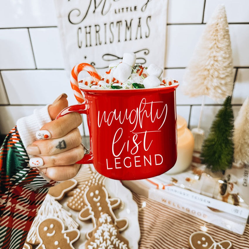 A vibrant red and green Naughty Legend Mug with white lettering, designed for holiday festivities, showcasing a playful naughty list theme.