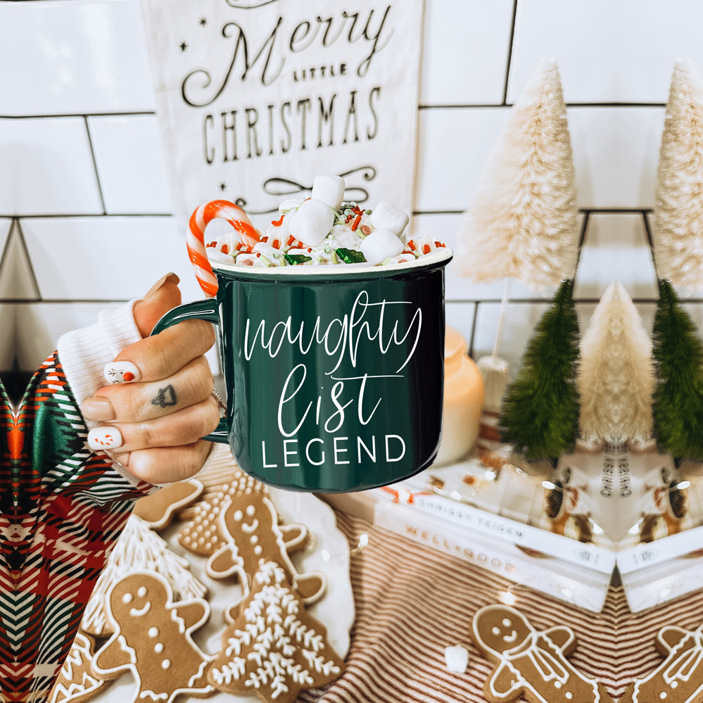 A vibrant red and green Naughty Legend Mug with white lettering, designed for holiday festivities, showcasing a playful naughty list theme.