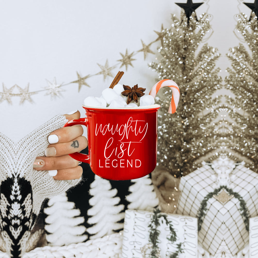 A vibrant red and green Naughty Legend Mug with white lettering, designed for holiday festivities, showcasing a playful naughty list theme.