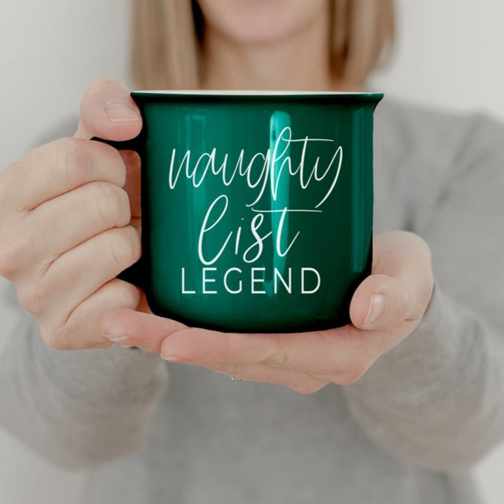 A vibrant red and green Naughty Legend Mug with white lettering, designed for holiday festivities, showcasing a playful naughty list theme.