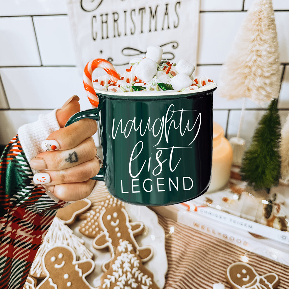 A vibrant red and green Naughty Legend Mug with white lettering, designed for holiday festivities, showcasing a playful naughty list theme.