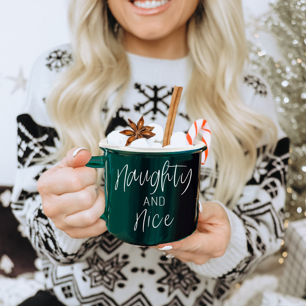 A vibrant Naughty & Nice Mug in red and green ceramic, featuring playful white lettering on both sides, perfect for coffee lovers.