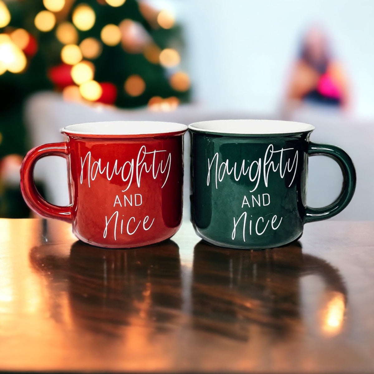 A vibrant Naughty & Nice Mug in red and green ceramic, featuring playful white lettering on both sides, perfect for coffee lovers.