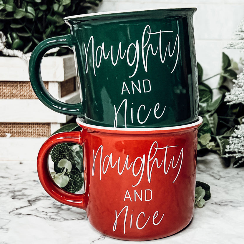 A vibrant Naughty & Nice Mug in red and green ceramic, featuring playful white lettering on both sides, perfect for coffee lovers.