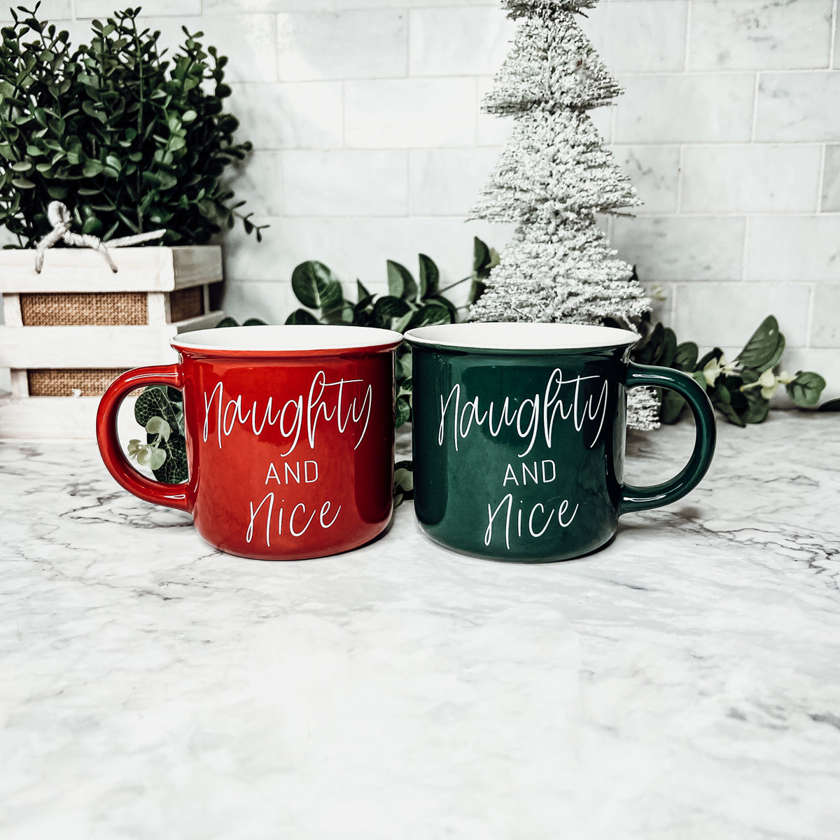 A vibrant Naughty & Nice Mug in red and green ceramic, featuring playful white lettering on both sides, perfect for coffee lovers.