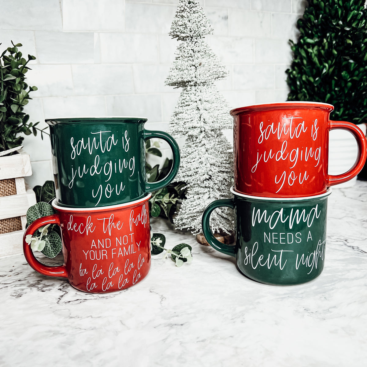 A vibrant Naughty & Nice Mug in red and green ceramic, featuring playful white lettering on both sides, perfect for coffee lovers.