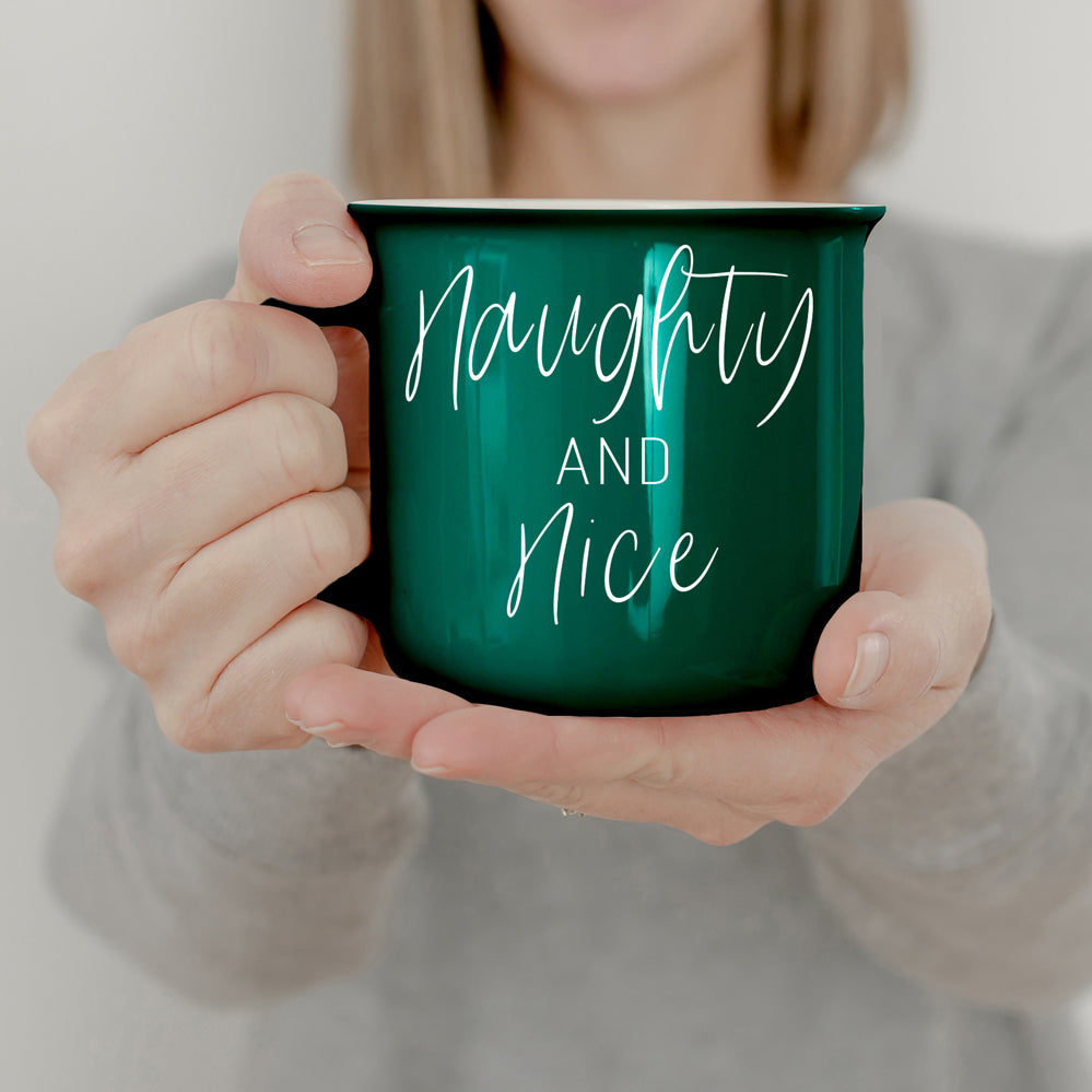 A vibrant Naughty & Nice Mug in red and green ceramic, featuring playful white lettering on both sides, perfect for coffee lovers.