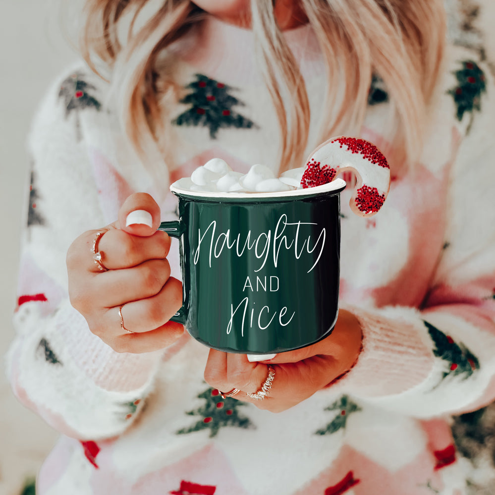 A vibrant Naughty & Nice Mug in red and green ceramic, featuring playful white lettering on both sides, perfect for coffee lovers.