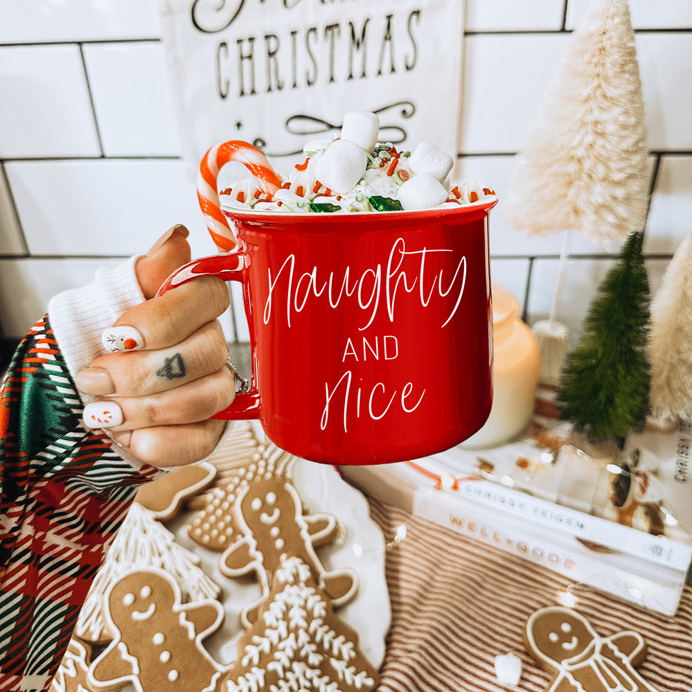 A vibrant Naughty & Nice Mug in red and green ceramic, featuring playful white lettering on both sides, perfect for coffee lovers.