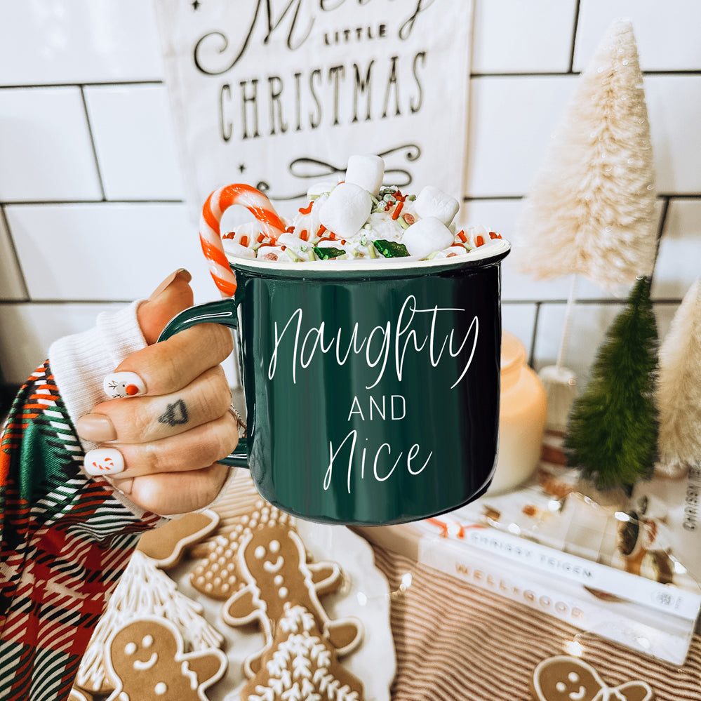 A vibrant Naughty & Nice Mug in red and green ceramic, featuring playful white lettering on both sides, perfect for coffee lovers.