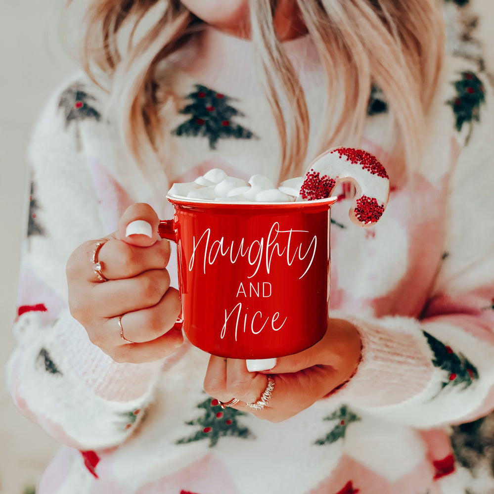 A vibrant Naughty & Nice Mug in red and green ceramic, featuring playful white lettering on both sides, perfect for coffee lovers.