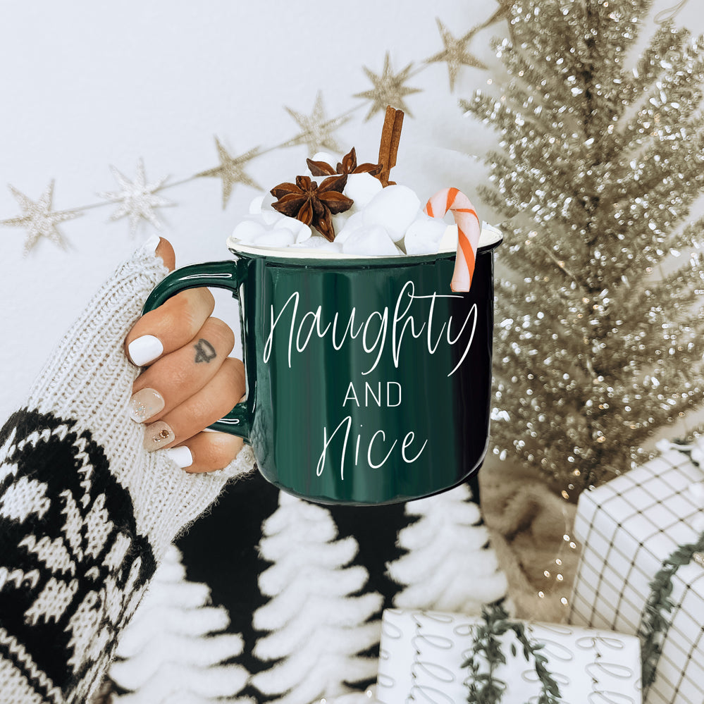 A vibrant Naughty & Nice Mug in red and green ceramic, featuring playful white lettering on both sides, perfect for coffee lovers.