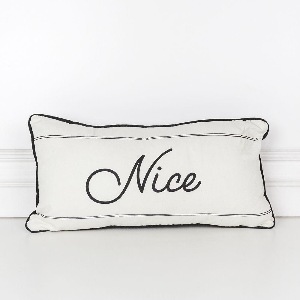 A reversible Naughty or Nice pillow featuring black and white colors, displaying 'Naughty' on one side and 'Nice' on the other, perfect for Christmas decor.