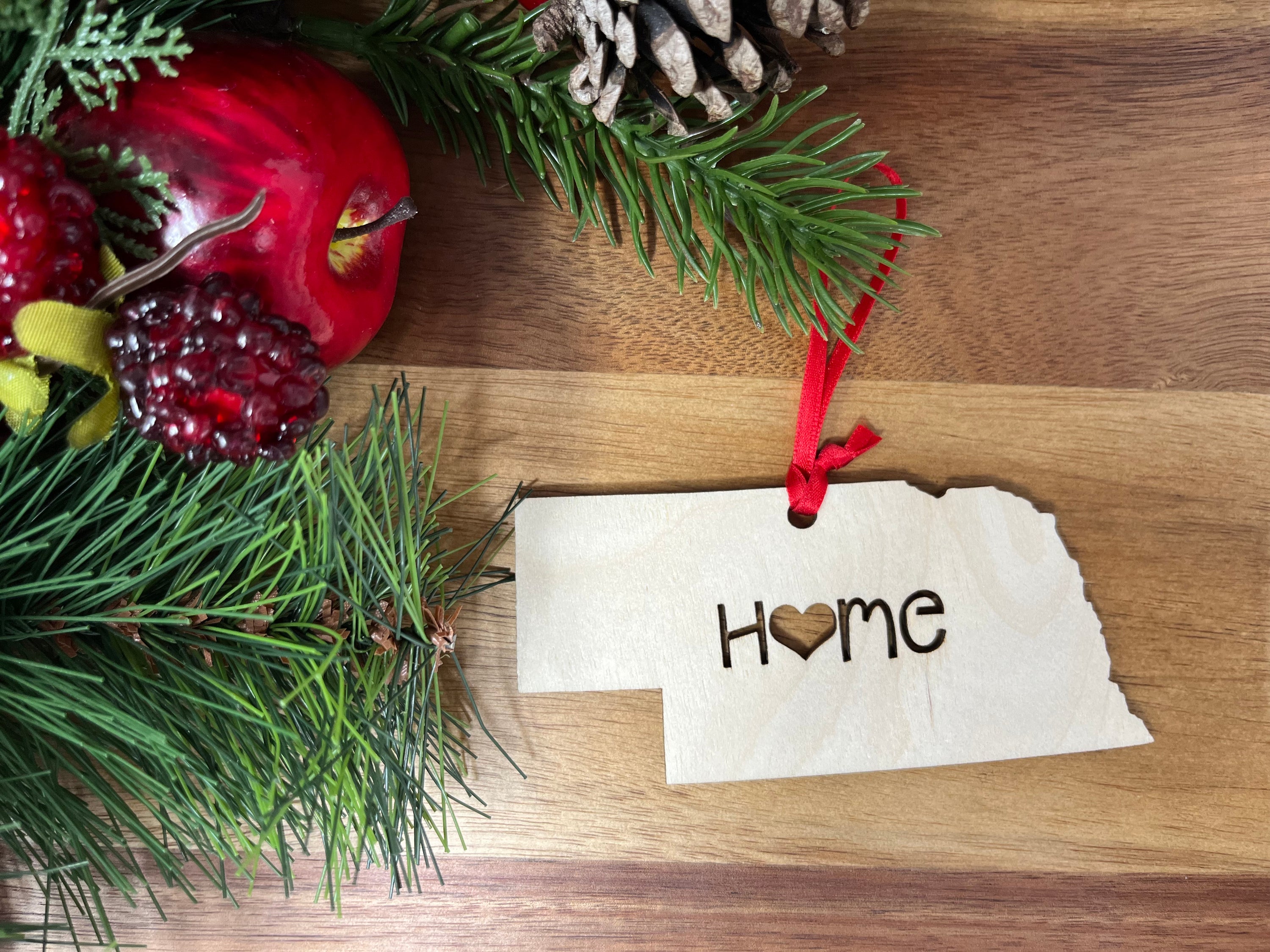 Nebraska State Wood Christmas Ornament made from Baltic Birch, featuring a 'Home' design, perfect for holiday decor.