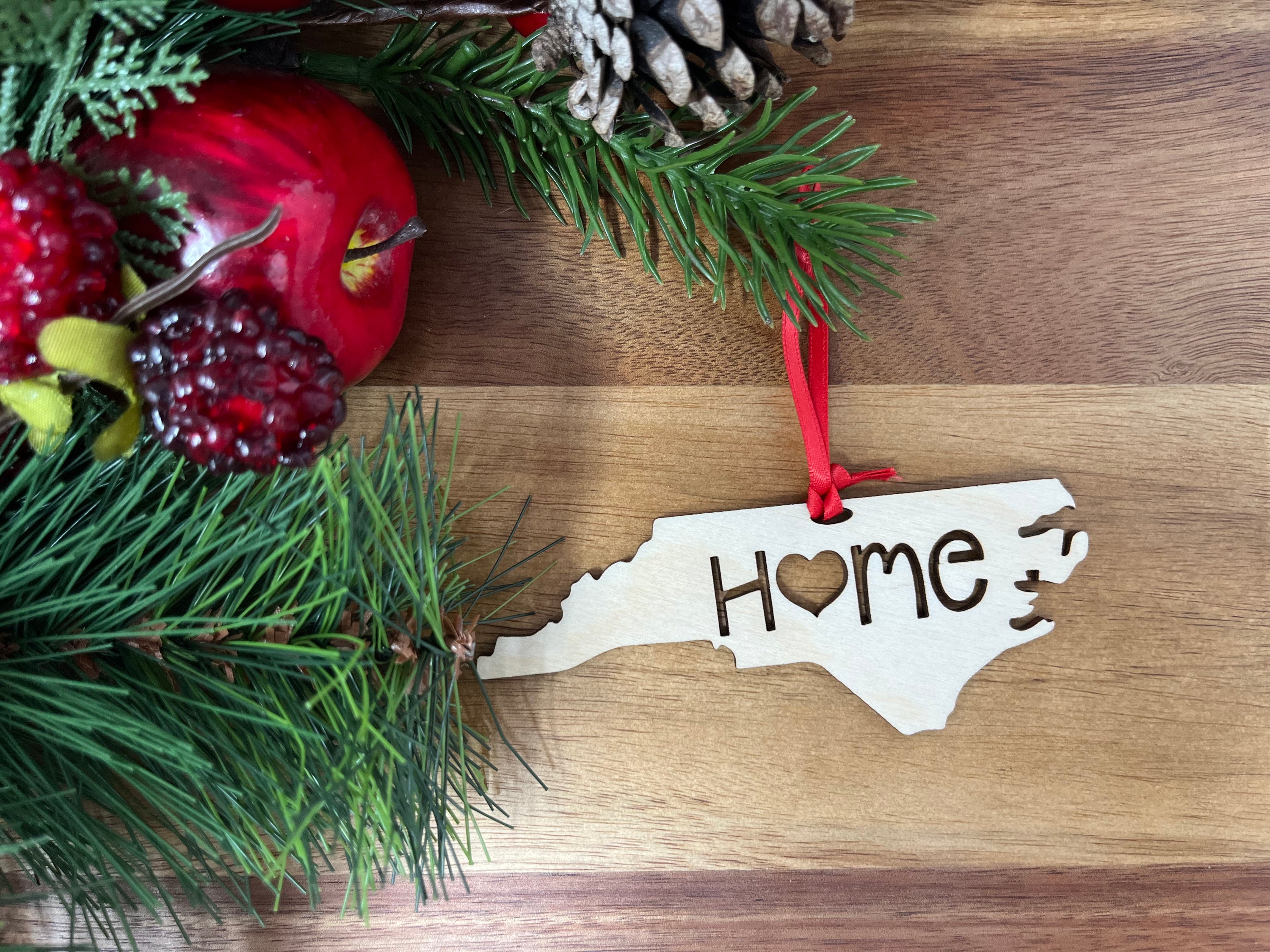 North Carolina State Wood Christmas Ornament made of Baltic Birch, featuring the word 'Home', beautifully packaged in a jewelry box.