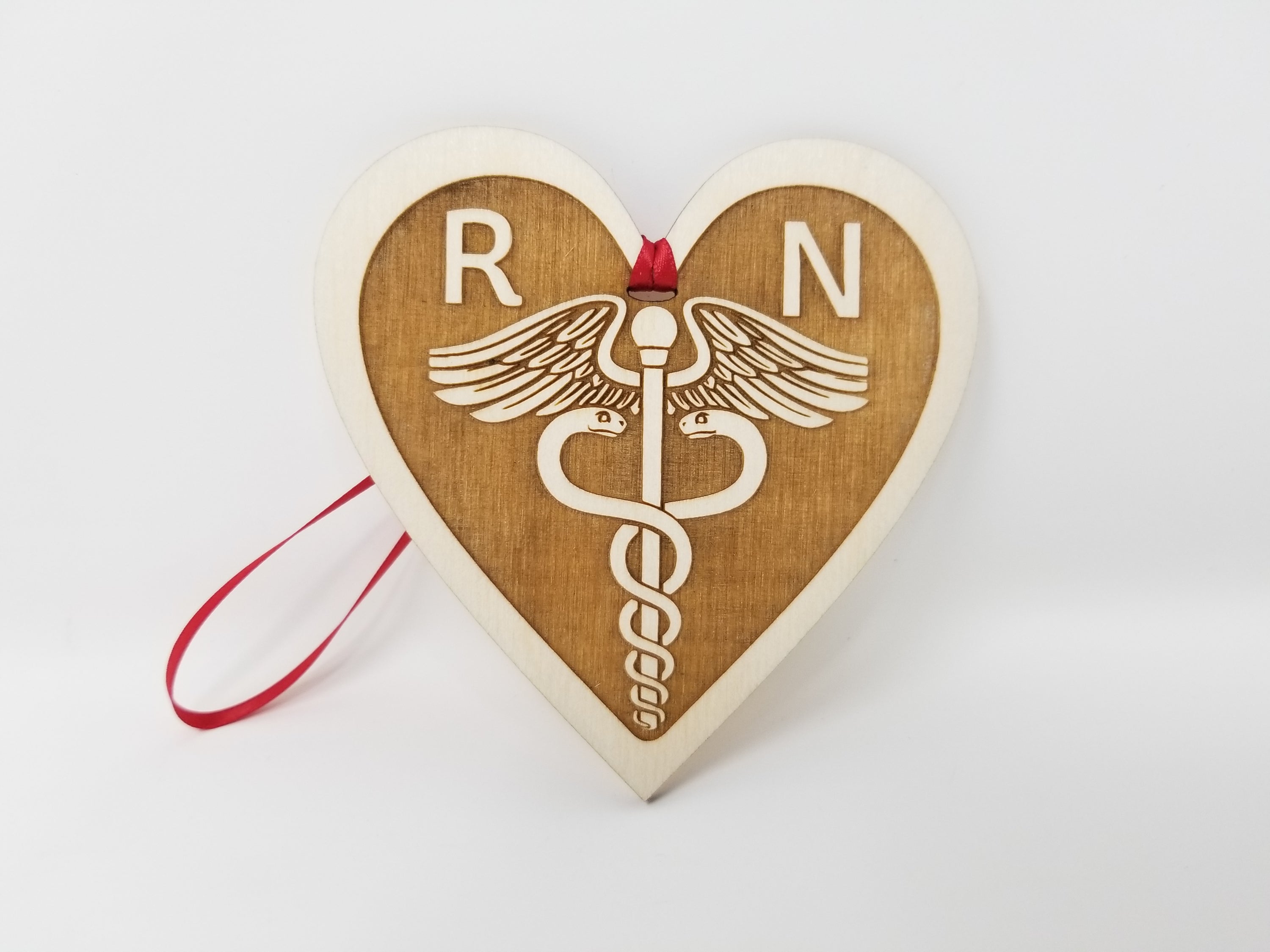 A beautifully handcrafted wooden ornament featuring the letters RN, measuring approximately 4 inches in diameter, perfect for celebrating nurses.