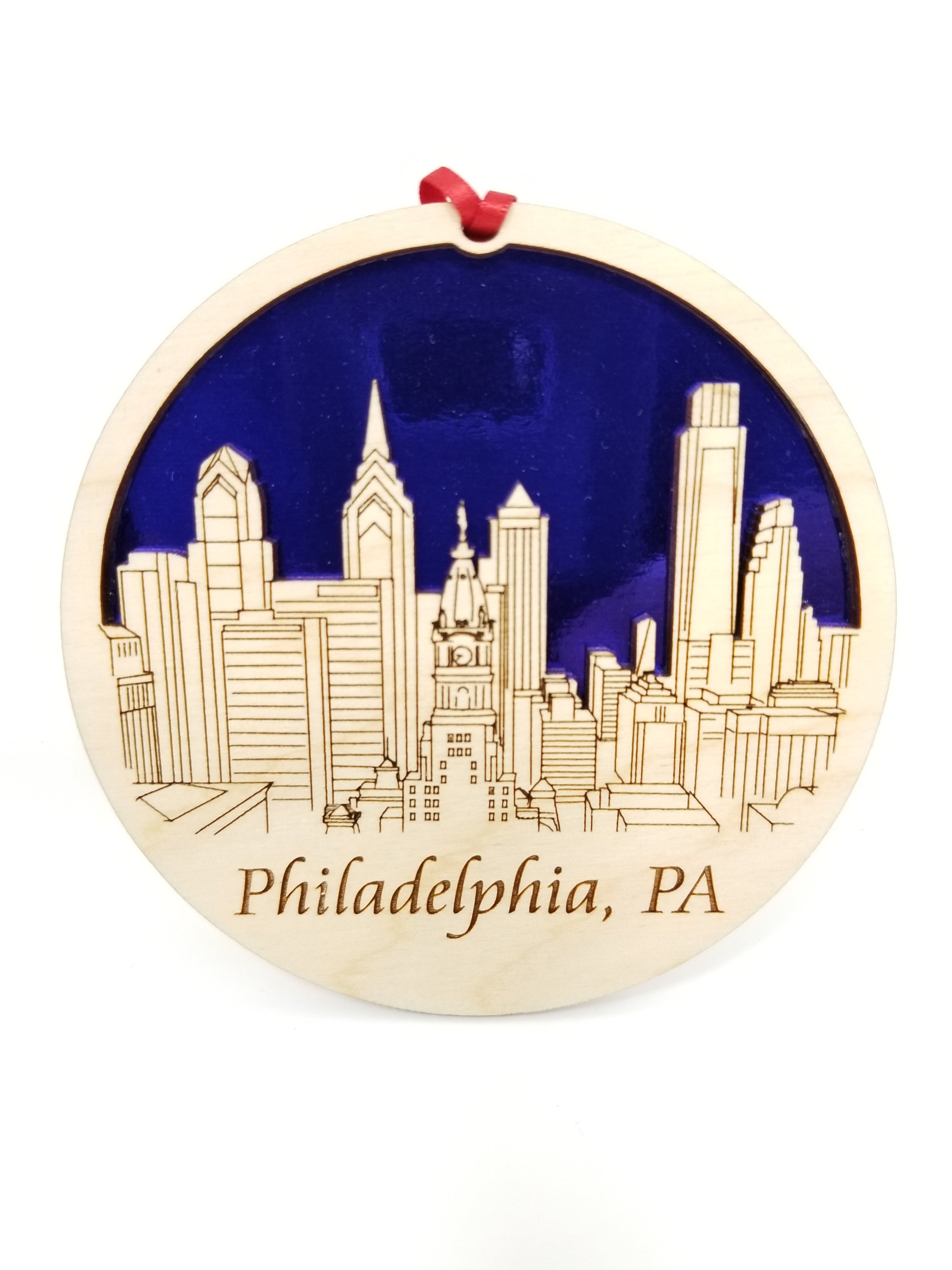 A beautifully crafted Philadelphia skyline ornament made from premium Baltic birch wood, showcasing intricate details of the city's skyline.