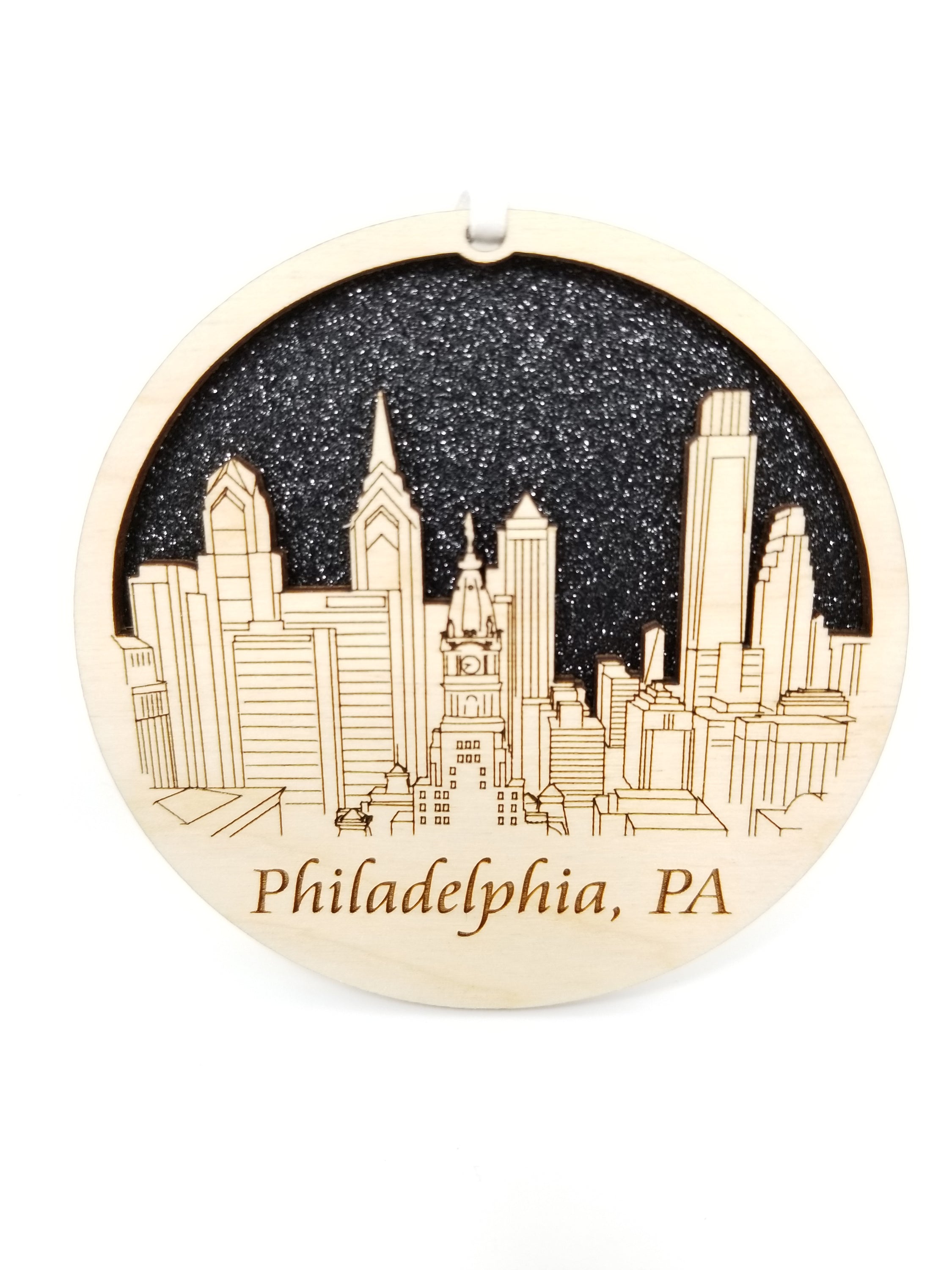 A beautifully crafted Philadelphia skyline ornament made from premium Baltic birch wood, showcasing intricate details of the city's skyline.