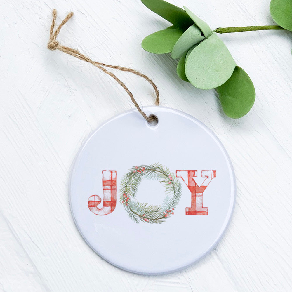 A beautifully crafted Plaid Joy Wreath Ornament made of high-quality porcelain, featuring a vibrant design perfect for holiday gifting.