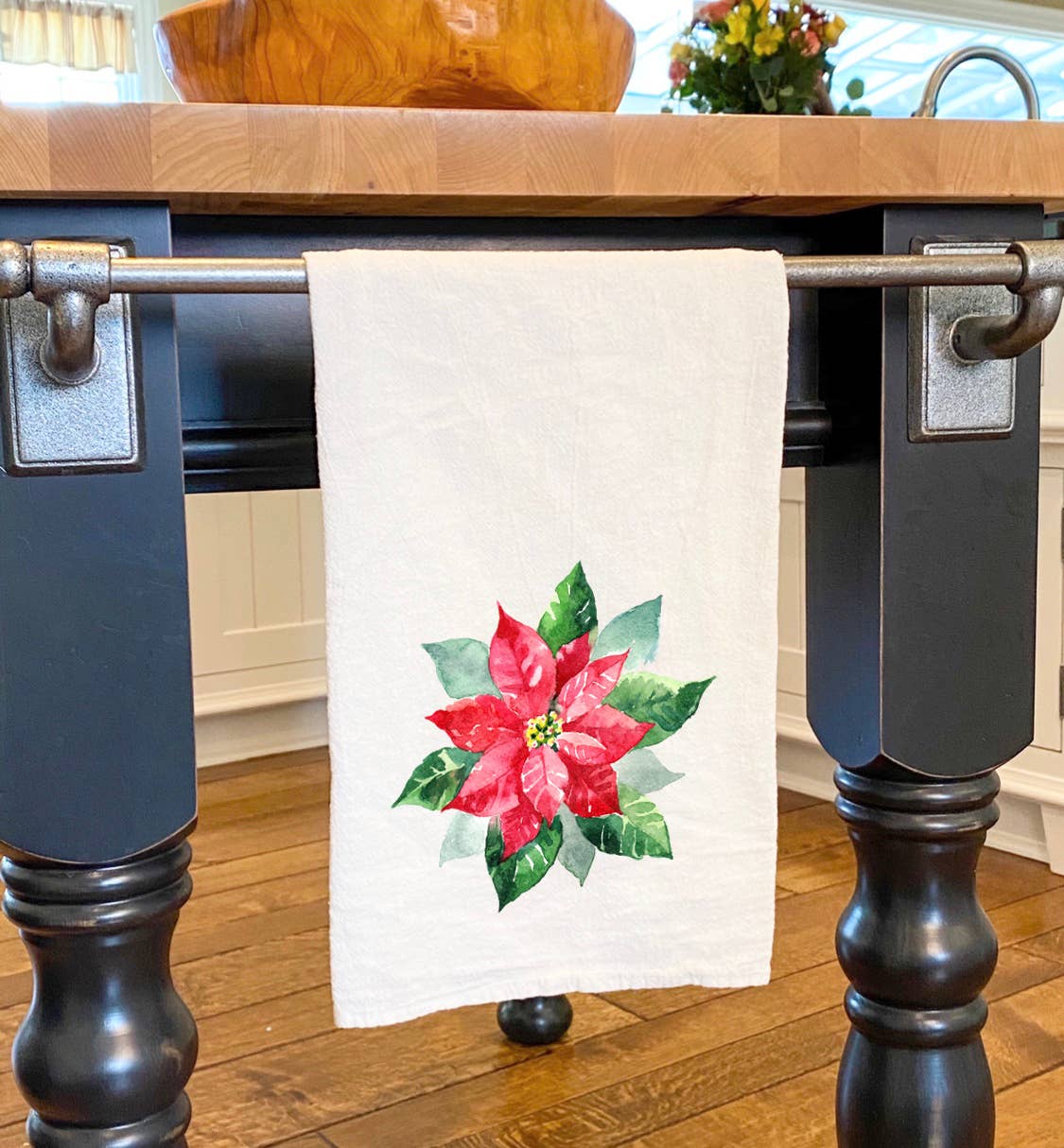 A vibrant Poinsettia Cotton Tea Towel featuring a beautiful floral design, perfect for kitchen use.