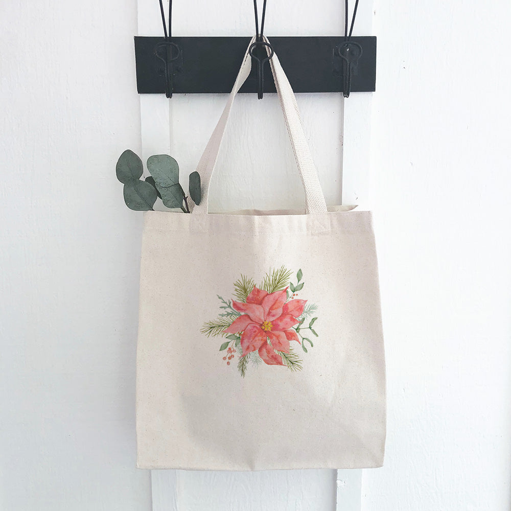 A vibrant Poinsettia Flower Canvas Tote Bag showcasing a beautiful floral design on durable fabric, perfect for eco-friendly shopping.