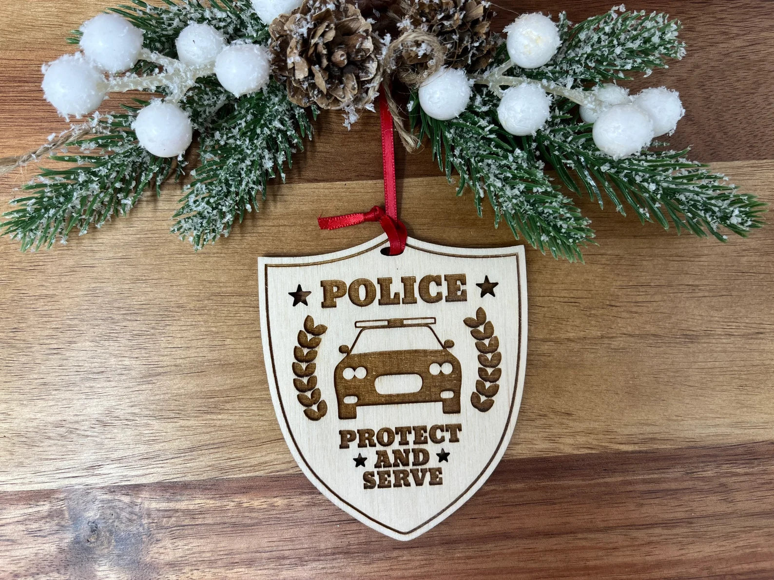 A beautifully crafted wooden Police ornament, approximately 4 inches in diameter, featuring intricate designs honoring first responders.