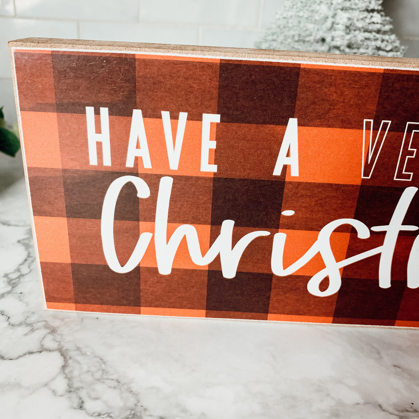 A festive Red Buffalo Christmas Sign made of thick wood, featuring a classic gingham pattern, perfect for holiday decor.