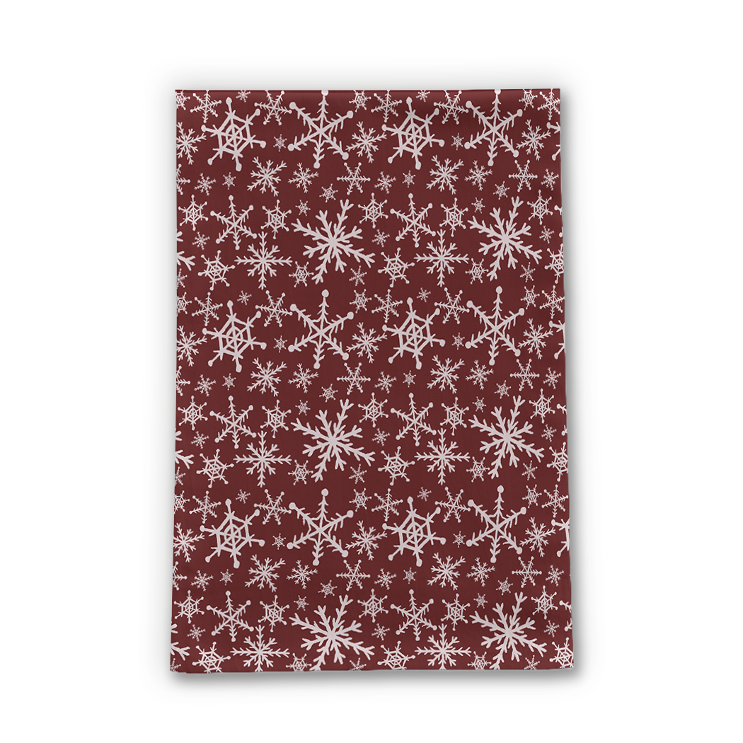 A vibrant red tea towel featuring white snowflakes, made of durable cotton twill, perfect for holiday kitchen decor.