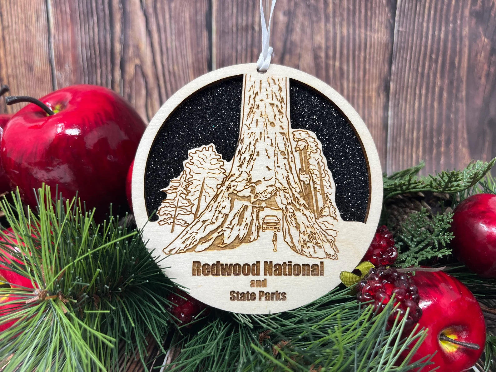 A beautifully crafted Baltic birch wood ornament featuring the skyline of Redwood National Park, perfect for holiday decor.