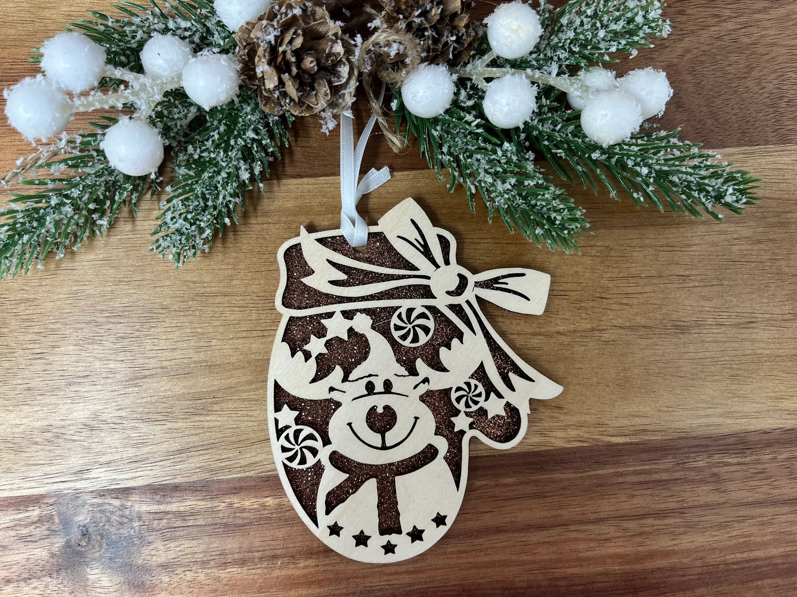 A beautifully crafted Reindeer Mitten ornament made from premium Baltic Birch wood, featuring intricate laser-cut details.