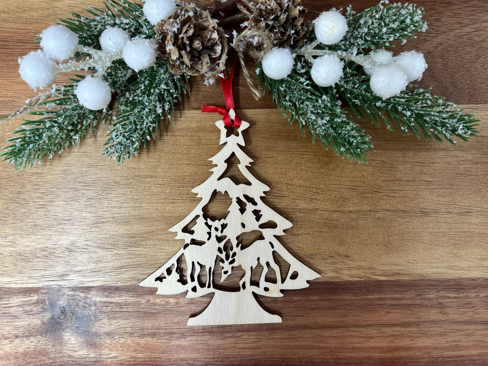 A beautifully crafted Reindeer Tree ornament made from premium Baltic Birch wood, featuring intricate laser-cut details and a charming design.