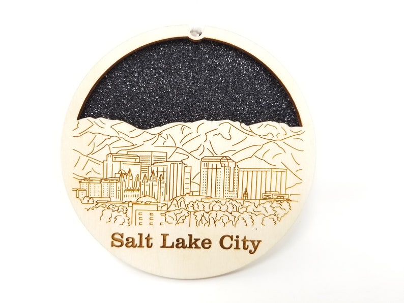 A beautifully crafted Salt Lake City skyline ornament made from premium Baltic birch wood, showcasing intricate skyline details.