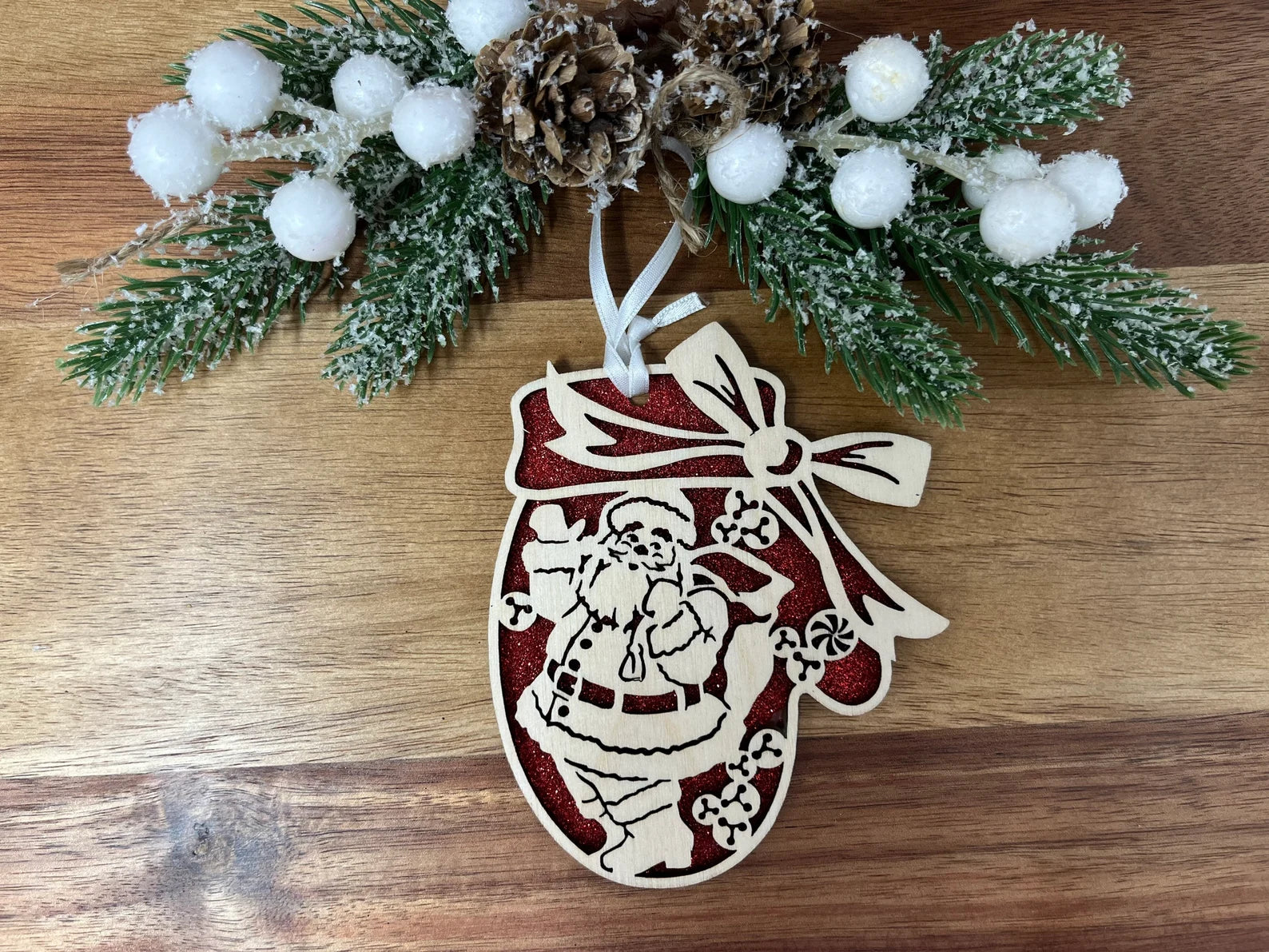 A beautifully crafted Santa Mitten Ornament made from premium Baltic Birch wood, featuring intricate laser-cut designs.