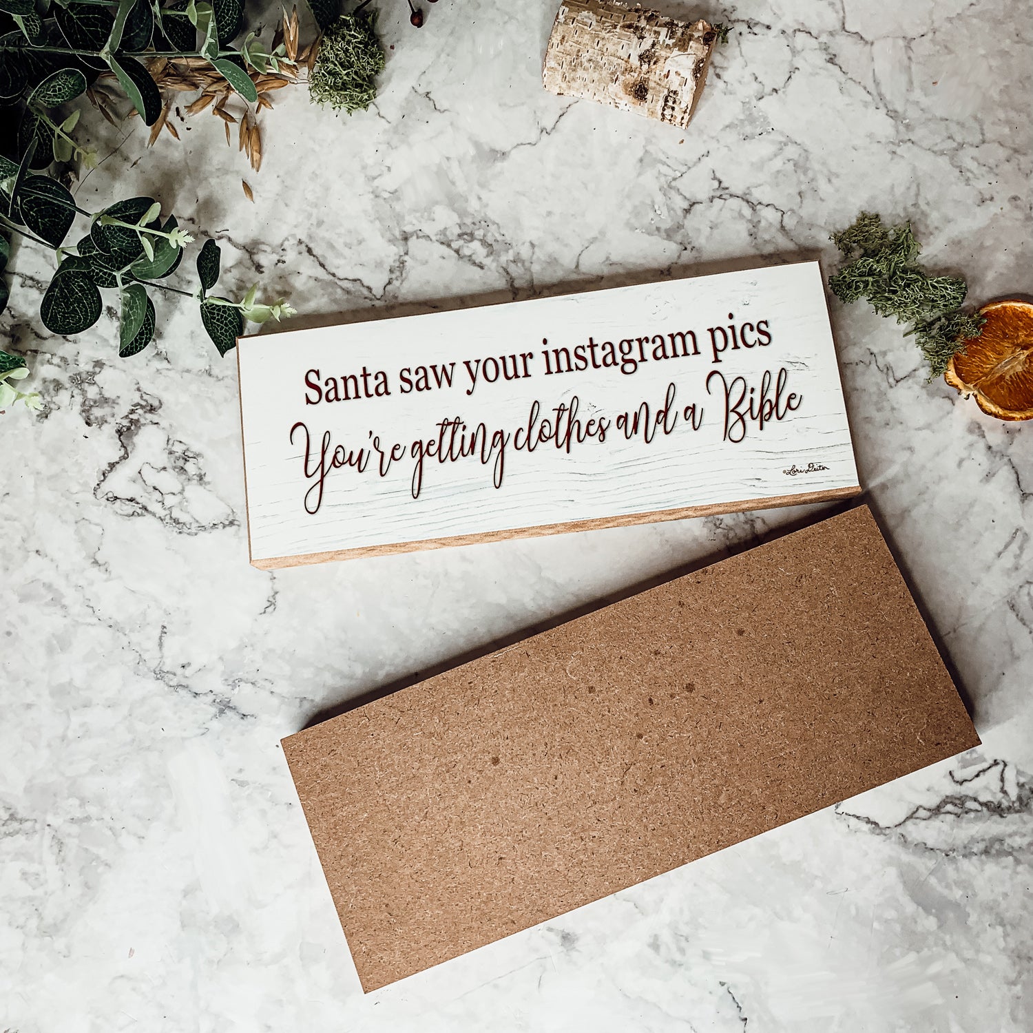 A humorous wooden sign reading 'Santa Seen Your Instagram & He’s Getting You Clothes & a Bible', perfect for holiday decor.