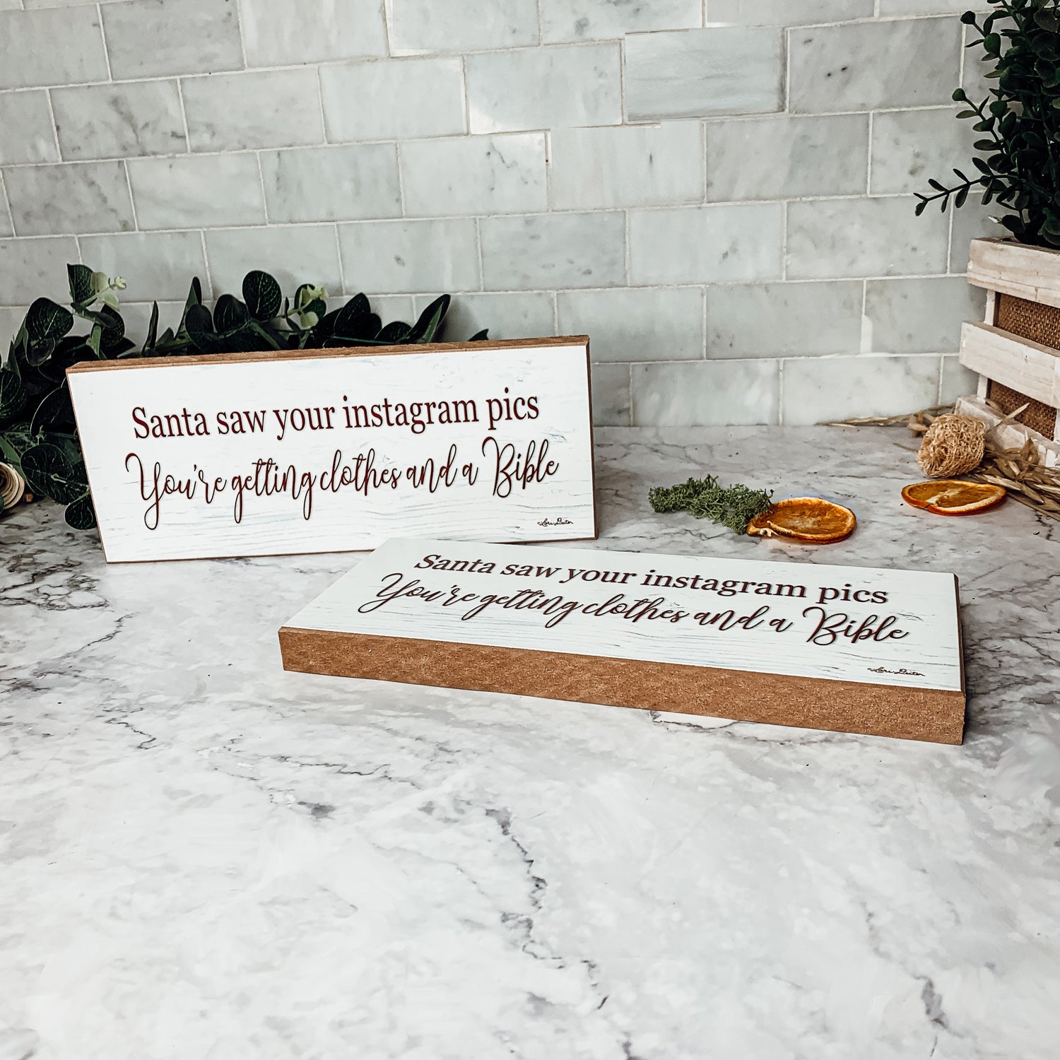 A humorous wooden sign reading 'Santa Seen Your Instagram & He’s Getting You Clothes & a Bible', perfect for holiday decor.