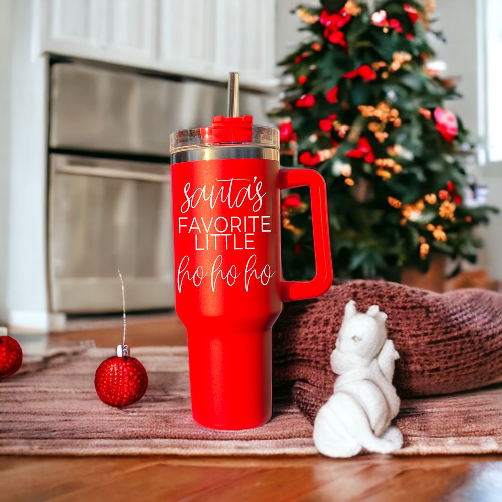 Santa's Ho 40oz insulated mug with a red exterior, featuring a humorous Santa graphic, lid, straw, and handle.