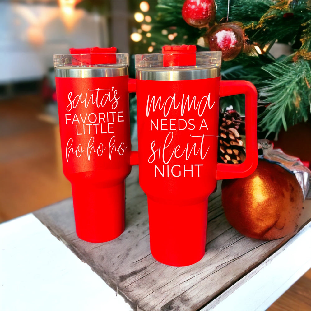 Santa's Ho 40oz insulated mug with a red exterior, featuring a humorous Santa graphic, lid, straw, and handle.