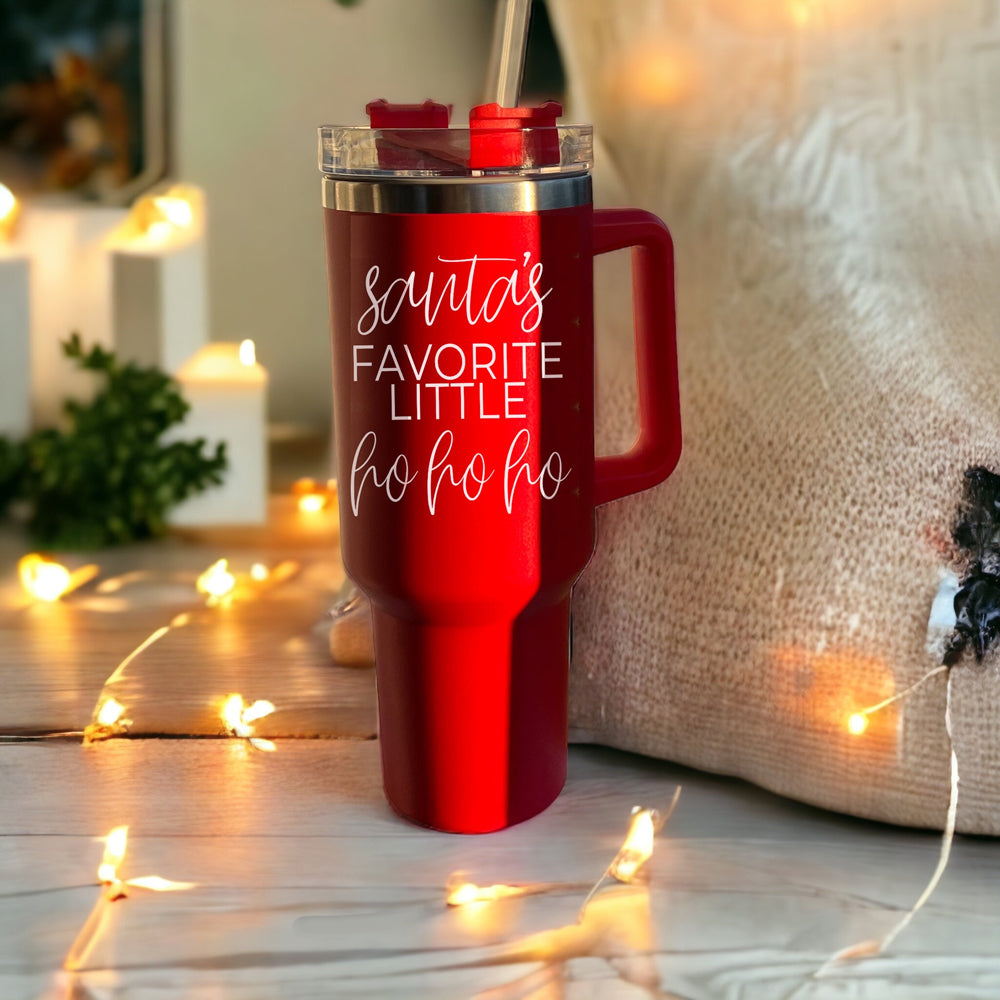 Santa's Ho 40oz insulated mug with a red exterior, featuring a humorous Santa graphic, lid, straw, and handle.