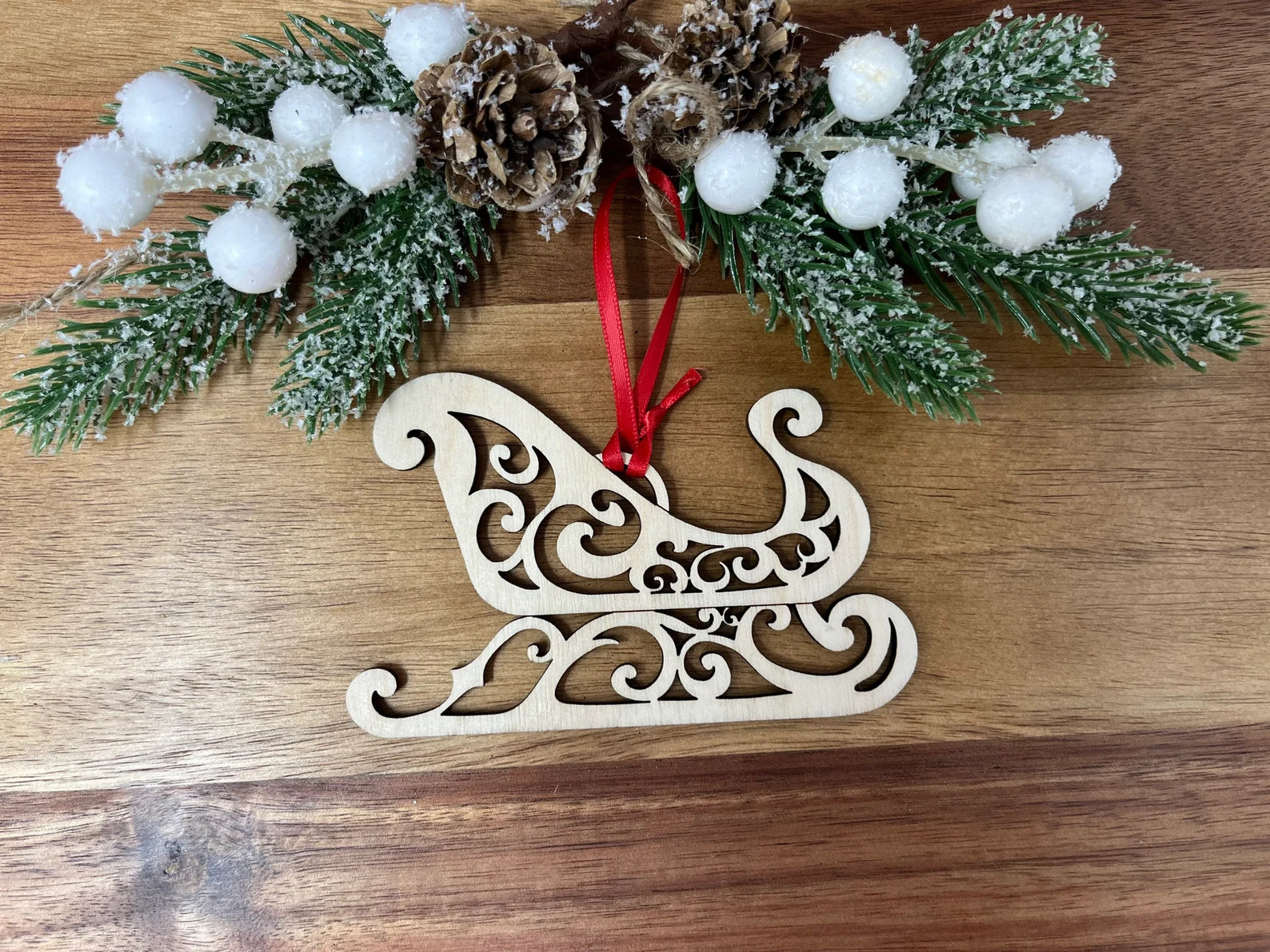 A beautifully crafted Santa's Sleigh ornament made from premium Baltic Birch wood, elegantly packaged in a jewelry box.