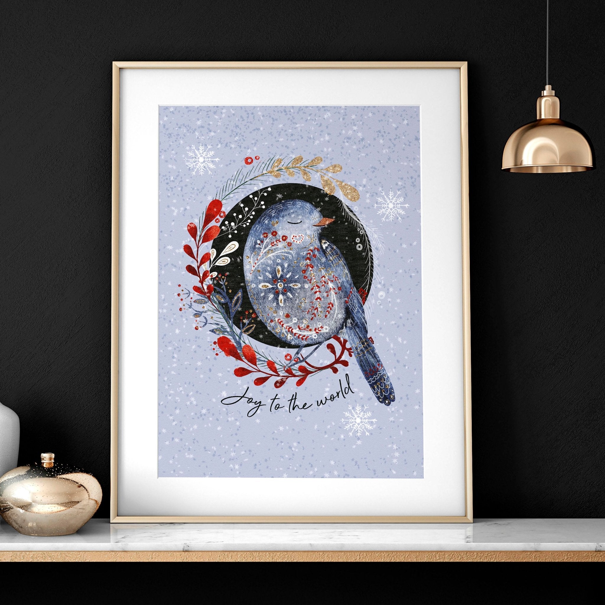 Scandi Christmas wall art print featuring a wreath with folk-style birds on a light blue snowed background.