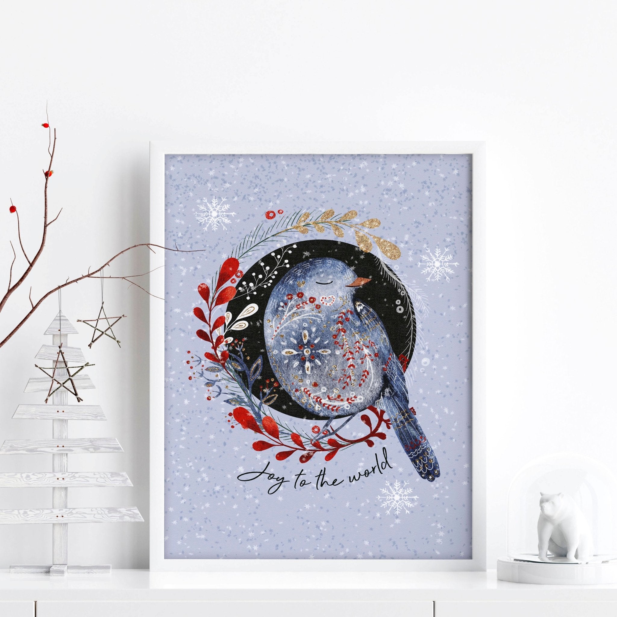 Scandi Christmas wall art print featuring a wreath with folk-style birds on a light blue snowed background.