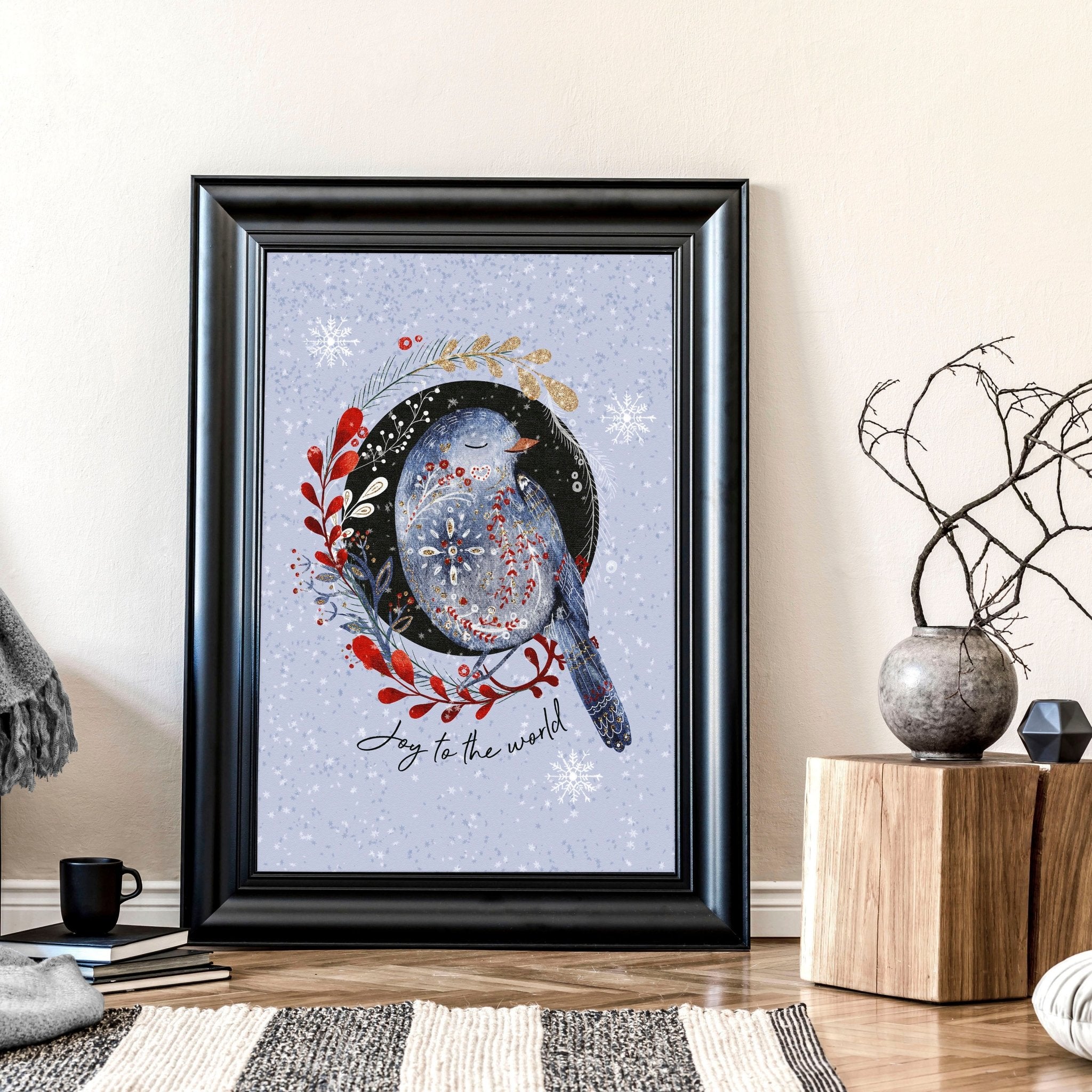 Scandi Christmas wall art print featuring a wreath with folk-style birds on a light blue snowed background.