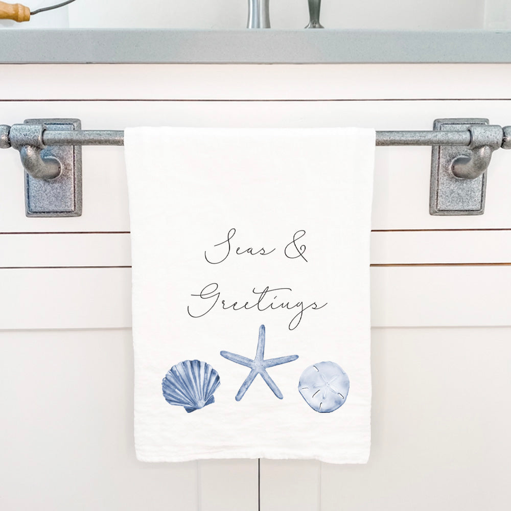 Seas & Greetings Cotton Tea Towel featuring vibrant design and hemmed edges, perfect for kitchen use.