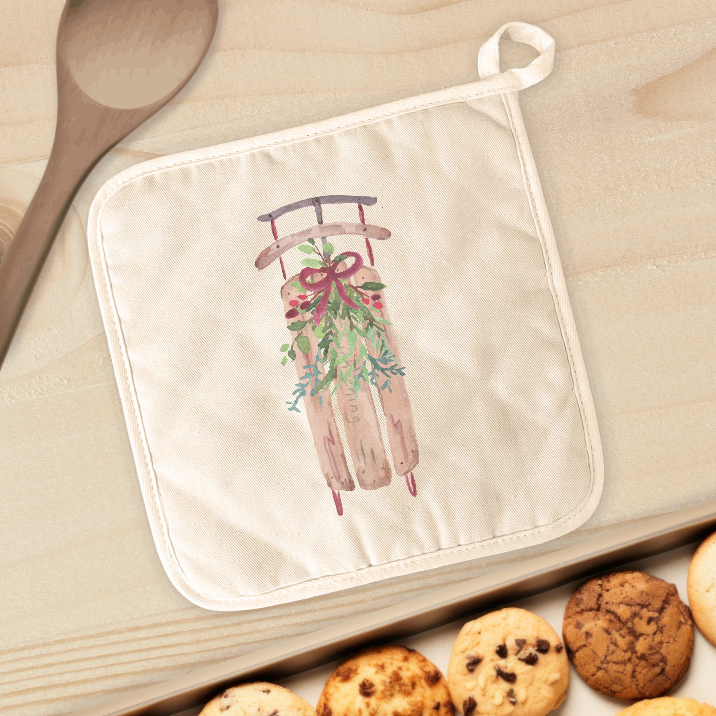 Sled with Mistletoe cotton pot holder featuring a festive design, perfect for protecting surfaces from hot cookware.