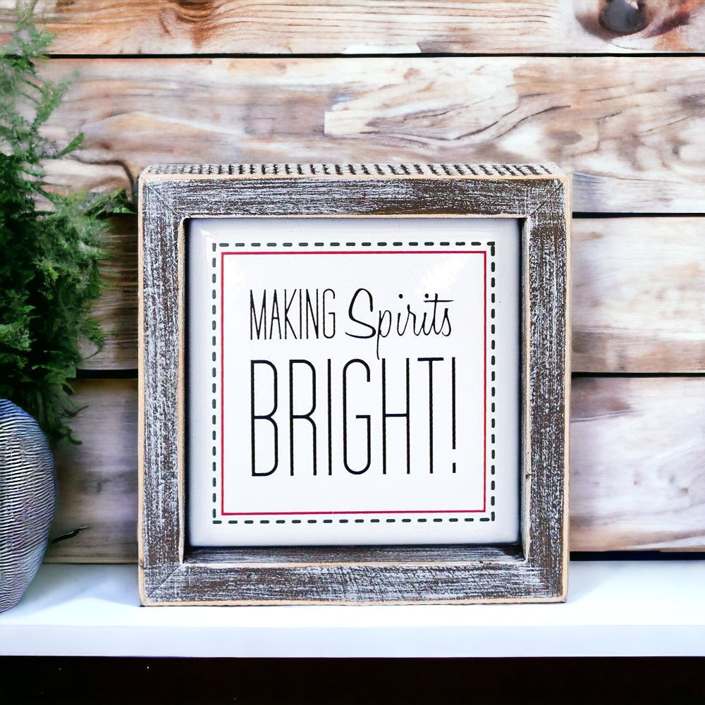 A 5-inch wooden framed sign with the text 'Making Spirits Bright' embossed in metal, featuring a festive red border.