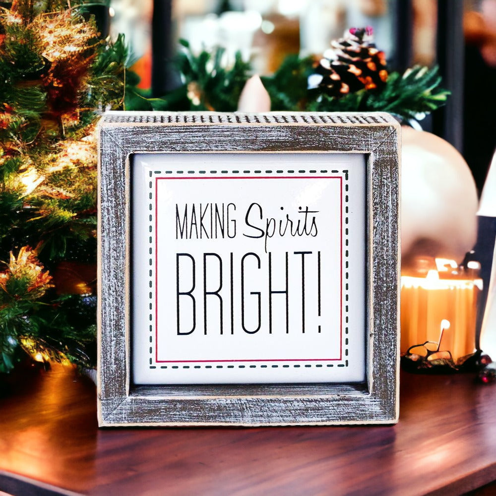 A 5-inch wooden framed sign with the text 'Making Spirits Bright' embossed in metal, featuring a festive red border.